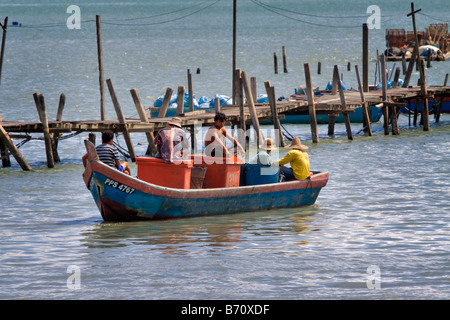 Malay fishing boat (sampan) at the pier with fishing nets 
