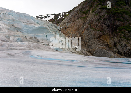 Mendenhall Glacier presses against mountains of rock near Juneau, Alaska Stock Photo