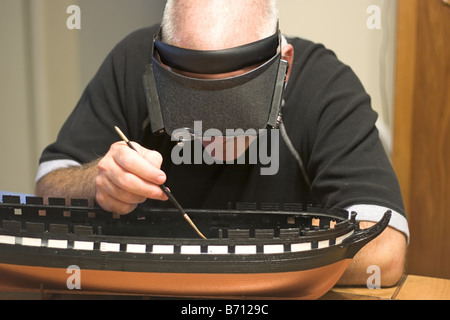 A craftsman building a replica of a battle ship Stock Photo