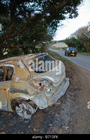 a car crashed and burnt out in a rural lane in cornwall,uk Stock Photo