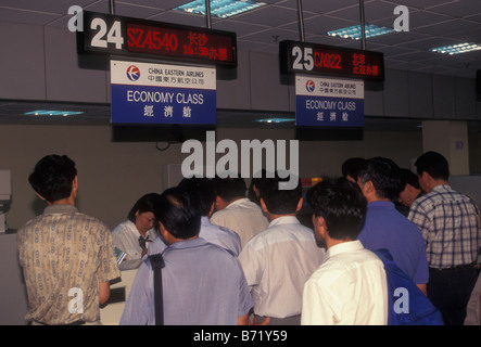 People tourists travelers at check in counter at Hongqiao International Airport Shanghai Shanghai Municipality China Asia Stock Photo