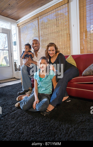 Happy girl on the couch at home in the living room Stock Photo - Alamy