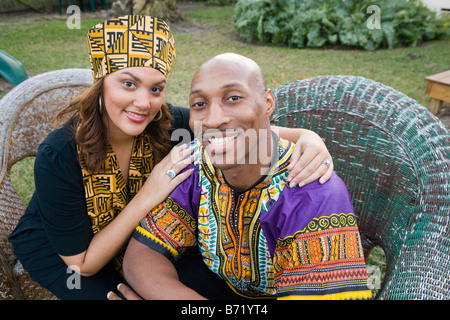 African American couple dressed in traditional African attire sitting outdoors Stock Photo