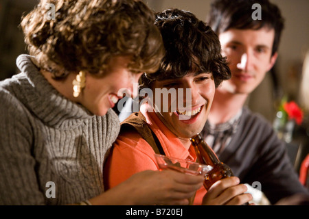 Young friends hanging out and drinking at bar together Stock Photo
