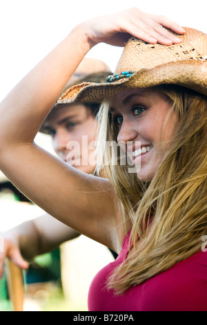 young couple smiling wearing cowboy hat Stock Photo