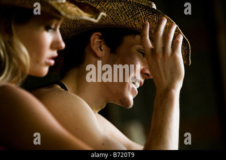 young couple smiling wearing cowboy hat Stock Photo