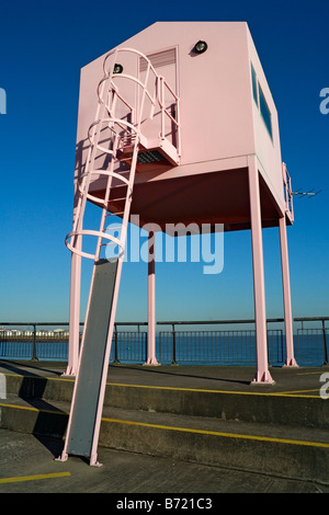 Pink hut lookout tower  building on the breakwater at Cardiff bay barrage, Wales. Welsh coast British coastline Stock Photo