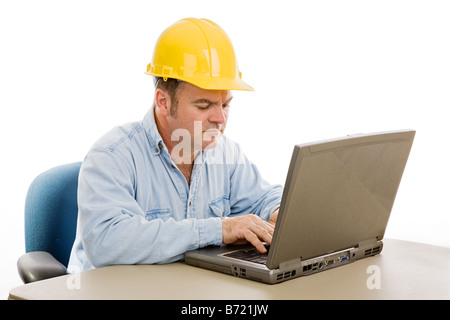 Construction contractor in the office on his laptop Isolated on white Stock Photo