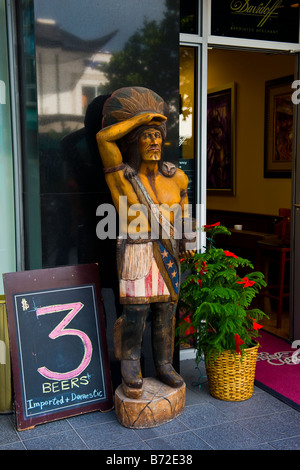 Wooden hand carved Indian cigar store sign, originated by tobacconists because tobacco was discovered by the Red Indians Stock Photo