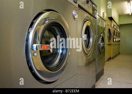 Washing machines and tumble dryers in a launderette. Stock Photo