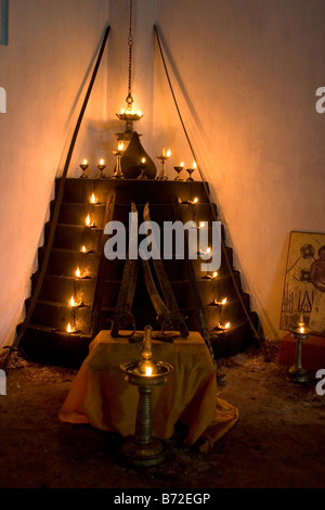 The seven tiers (puttara) of lamps (guruthara) in the south west corner of a kalari burn before a Kalarippayattu performance. Stock Photo
