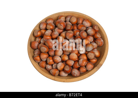 Bowl of hazelnuts cut out on white background Stock Photo