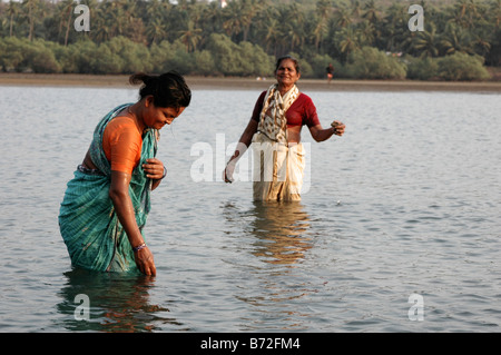 India Goa Two local woman bathing in the river Stock Photo