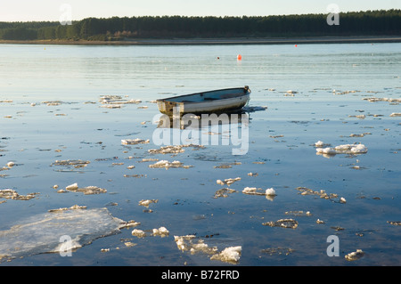 Rowing boat on a ice covered Findhorn bay Stock Photo