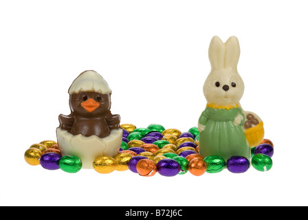 cute easter bunny and chick surrounded by chocolate easter eggs isolated on a white background Stock Photo