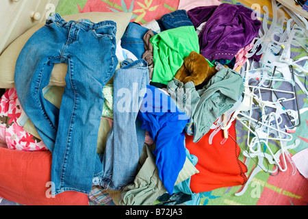 A pile of clothes on the floor in a teenager's bedroom. Stock Photo
