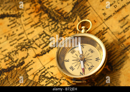 Antique golden compass and old map Stock Photo