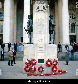 People stand in silence on Remembrance Day Armistice Day outside the Royal Exchange War Memorial London England   UK  KATHY DEWITT Stock Photo