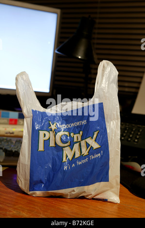 Woolworths pickandmix plastic bag in the work place placed infront of a computer screen on an office desk Stock Photo
