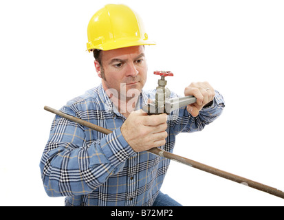 Construction plumber working on a faucet Isolated on white Stock Photo