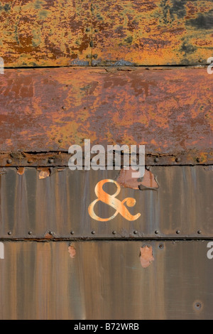 The word symbol & painted on side of old rusty train car Stock Photo