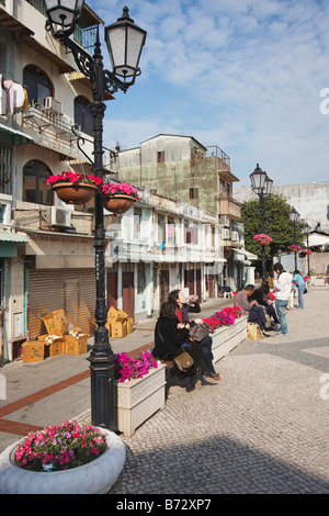 People Sitting In Square in Taipa Village, Macau Stock Photo