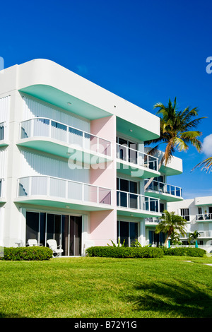 Palm Beach Shores , bright green, pink & white art deco apartment block or condominiums with balconies & windows & palm trees Stock Photo