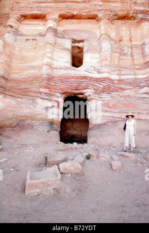 Tourist outside a rock temple in Petra Jordan the [Rose Red City] in the Middle East a UNESCO world heritage site Stock Photo