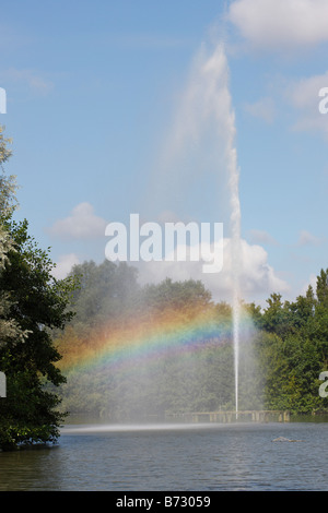 Water feature in park creating a rainbow in its spray Stock Photo