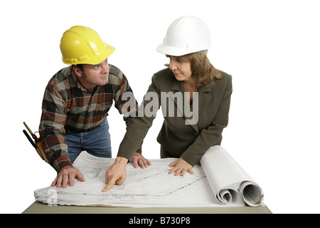 A female engineer going over blueprints with a building contractor Isolated on white Stock Photo