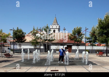 Tourists enjoying the fountain in Jardim do Mar Stock Photo