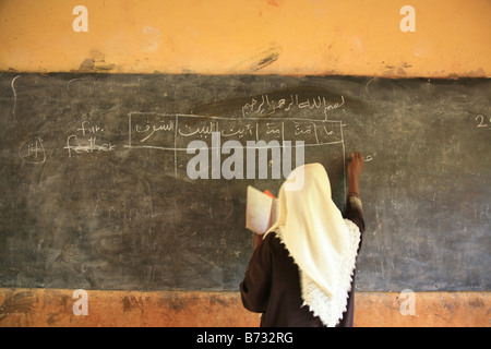 A teacher from the Islamic school in Sunyani Ghana writing arabic sentences on the black board In Ghana coranic schools were tr Stock Photo