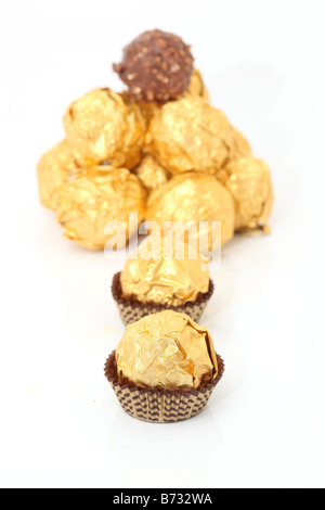 gold wraped chocolate sphere dessert isolated on white background Stock Photo