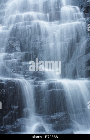 Icy cold waterfall spilling over wet rock in the Hogsback Forest, Eastern Cape, South Africa Stock Photo