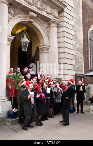 Carol singers outside St. Mary Le Bow Church, Cheapside, London, UK Stock Photo