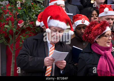 Carol singers outside St. Mary Le Bow Church, Cheapside, London, UK Stock Photo