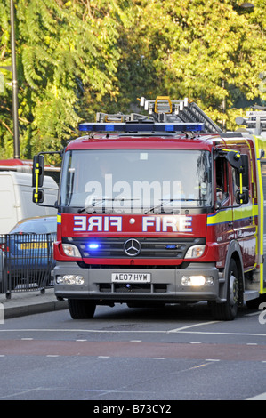 Fire engine with flashing blue lights Euston Road Camden London England UK Stock Photo