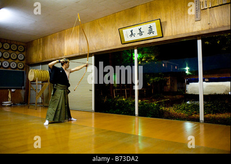 A Kyudoka stringing his bow in a Dojo in Yudanaka, Japan Stock Photo ...