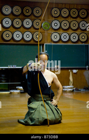 A Kyudoka stringing his bow in a Dojo in Yudanaka, Japan Stock Photo ...