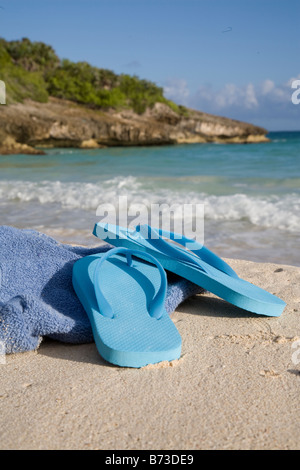 Blue flip flops and towel on sandy beach in Vieques Puerto Rico Stock Photo