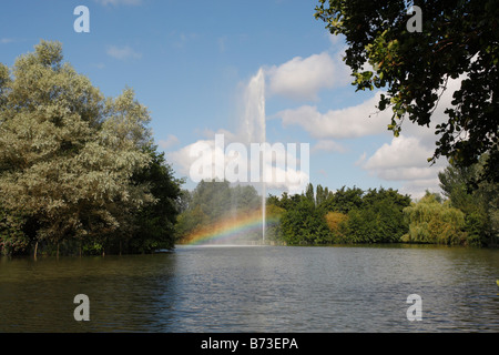 Water feature in park creating a rainbow in its spray Stock Photo