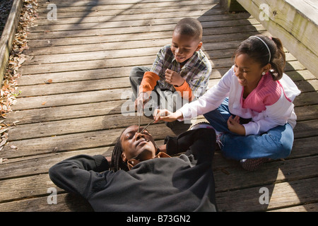African American father with children outdoors on boardwalk Stock Photo