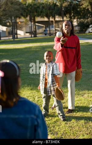 African American family playing softball Stock Photo