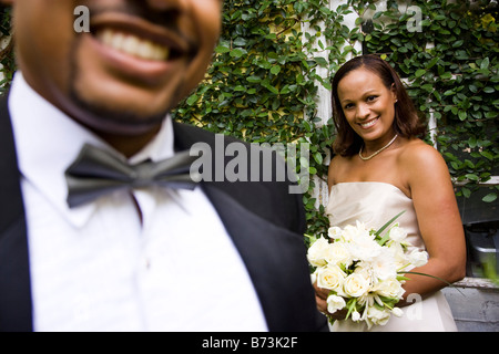 Happy African-American bride, close up of smiling groom in foreground Stock Photo