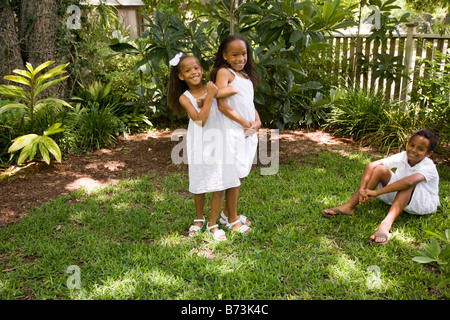 Happy African-American children playing in back yard Stock Photo