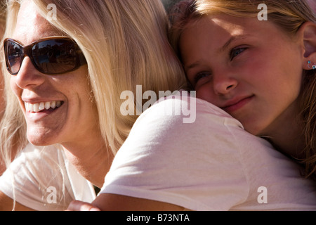 Profile of mother and daughter on a sunny summer day Stock Photo