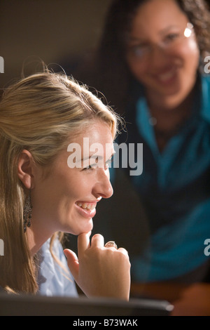 Profile of female office worker sitting at desk Stock Photo