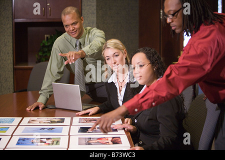 Multi-racial marketing executives reviewing presentation Stock Photo
