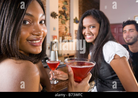 Multi-racial friends having drinks in restaurant Stock Photo