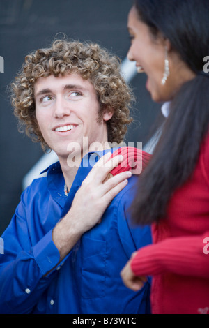 Side view of a couple of teenagers dating and flirting falling in love